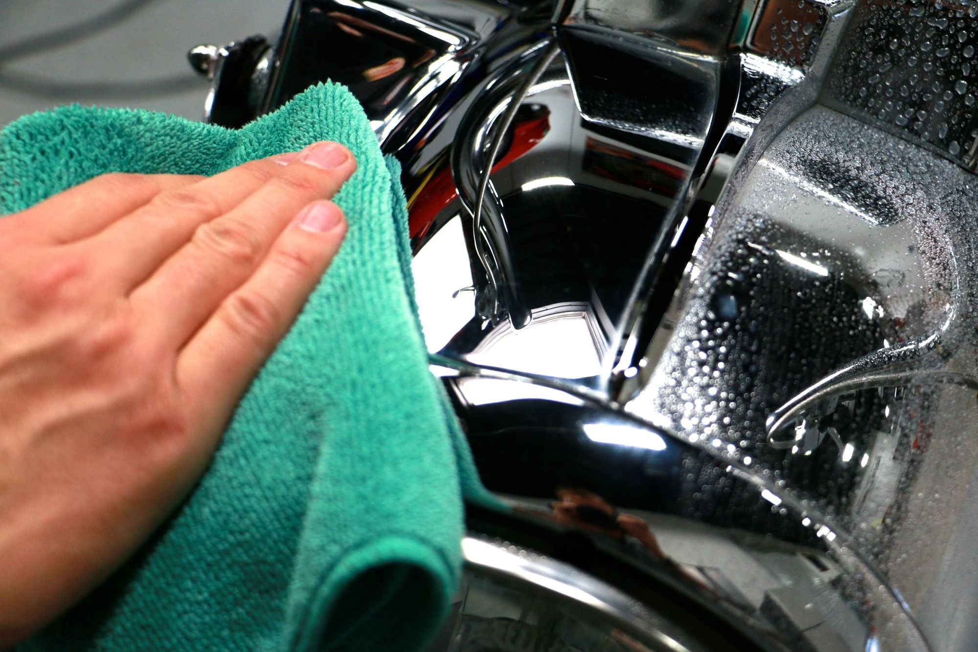 Green Workhorse Microfiber Towel wiping down a motorcycle.