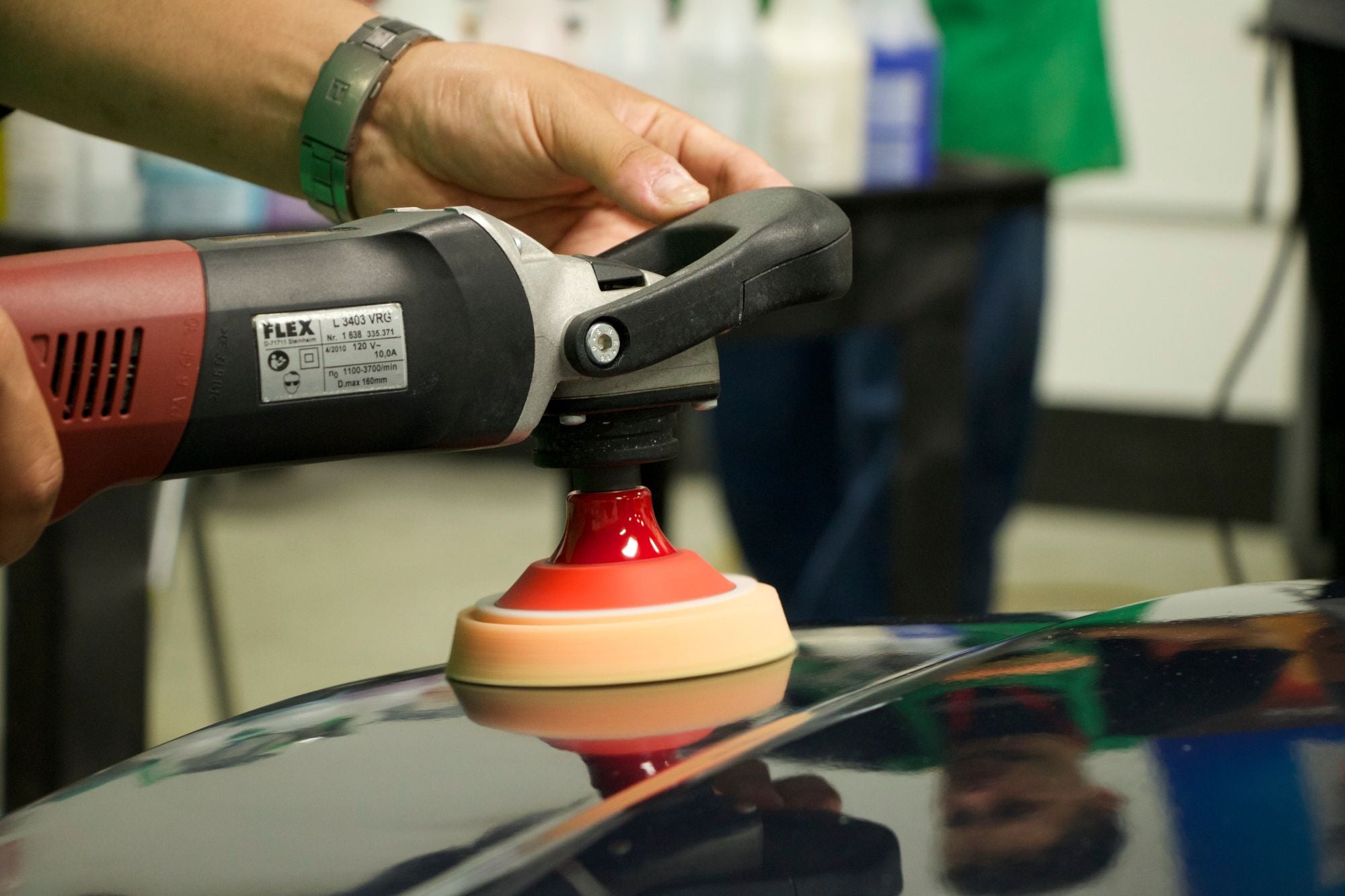 Polishing a vehicle with a TORQ R5 backing plate, an orange polishing pad, and a rotary polisher.