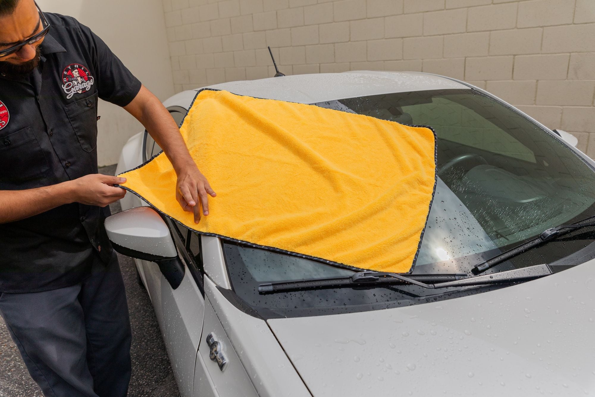 Miracle Dryer Towel unfolded to quickly and easily wipe down a windshield.