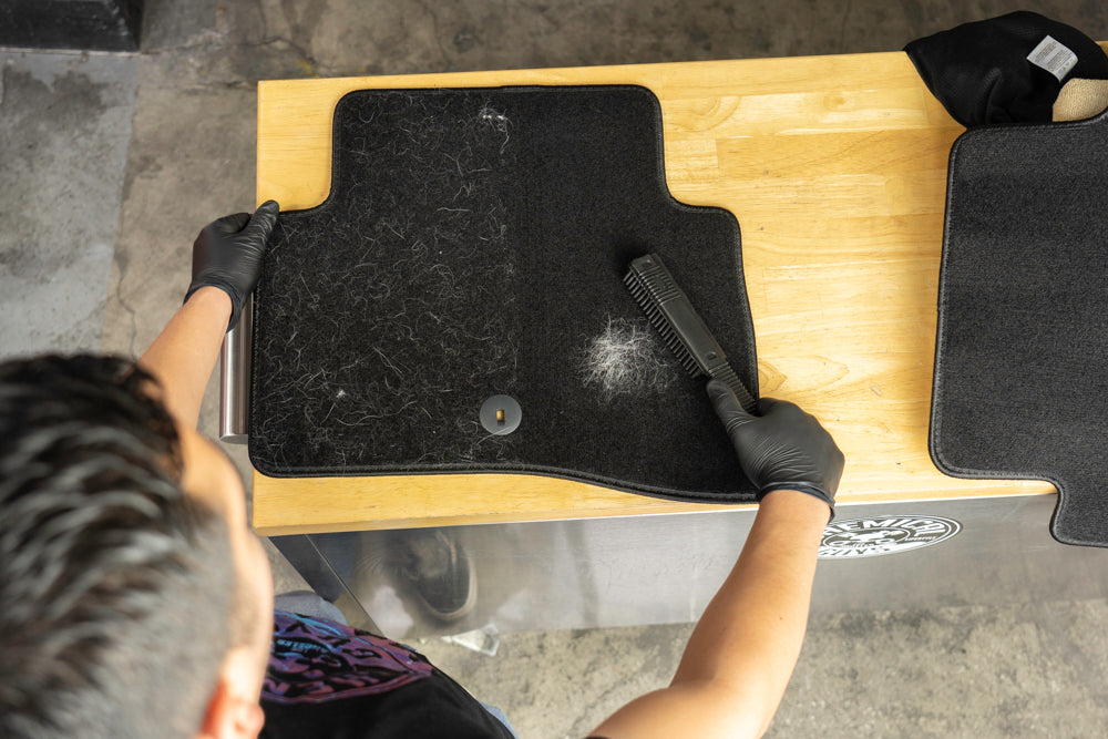 Side by side using Professional Rubber Pet Hair Removal Brush to remove pet hair from a floorboard mat.