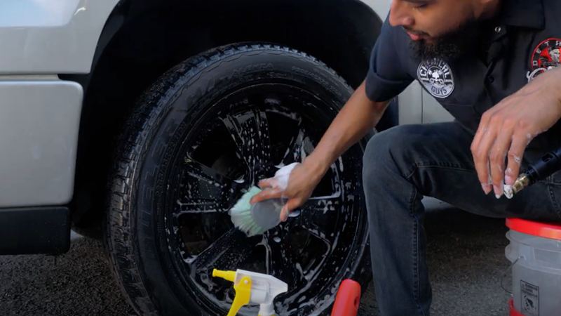 Using Stiff Bristle Brush to Scrub Wheels