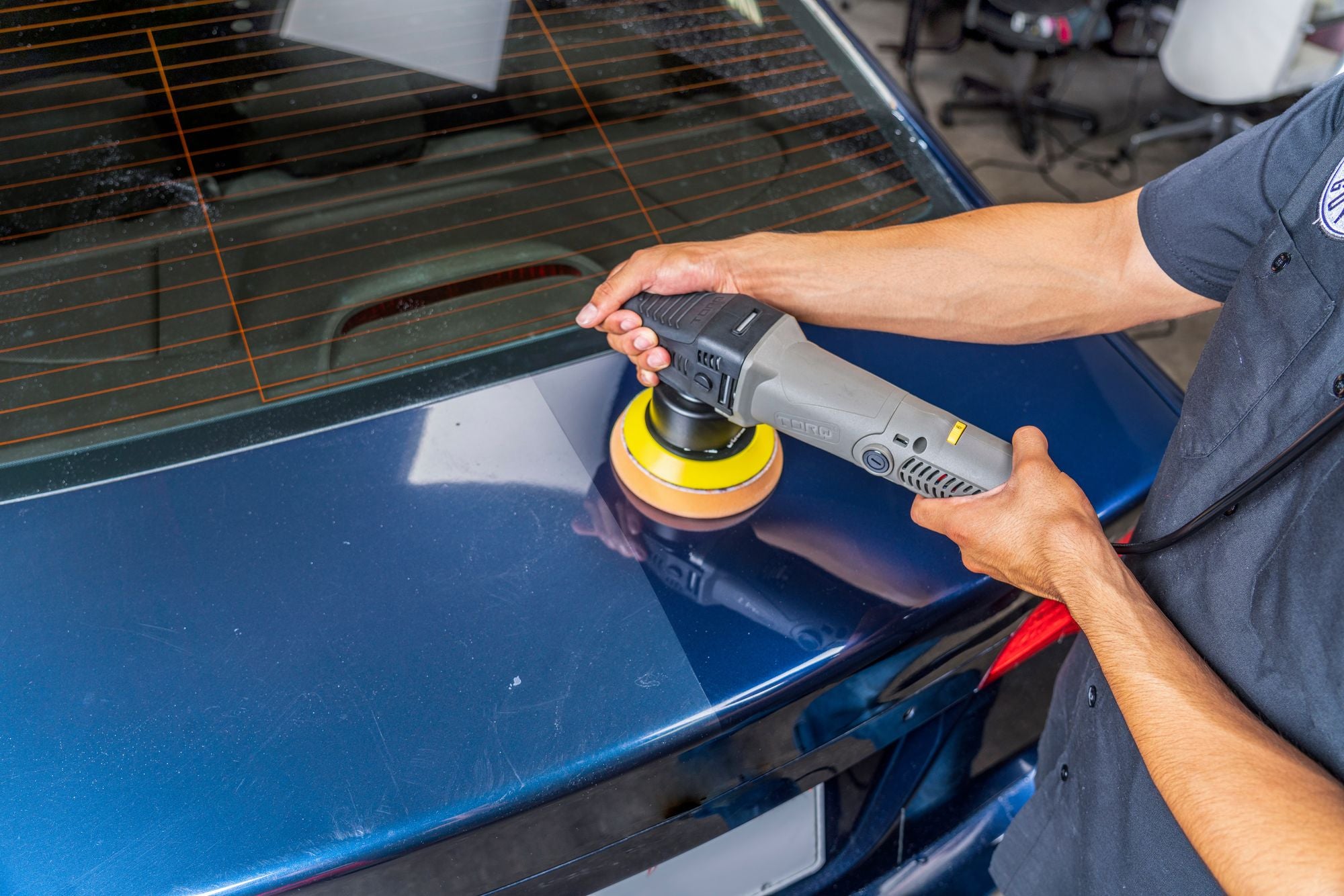 In-progress polishing of the rear of a car using the TORQX Polisher