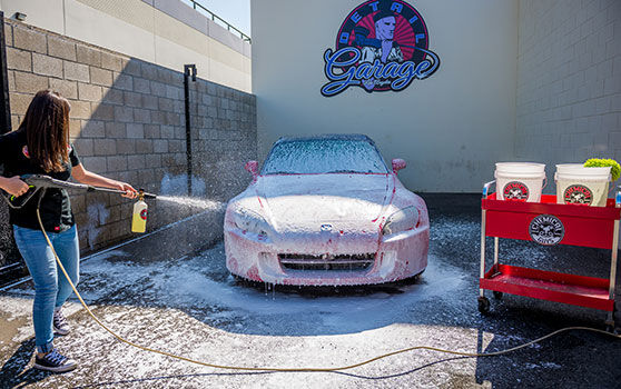 Spraying Soap to Wash a Car