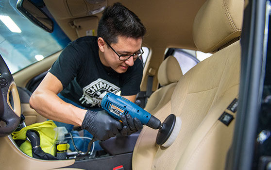 Using a Drill Brush Attachment to Clean Car Seat