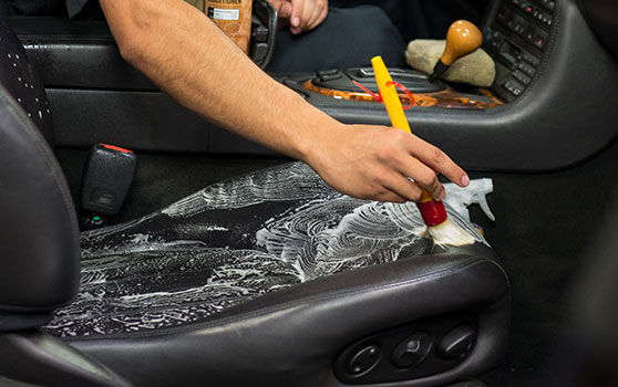 Scrubbing Leather Seats with a Brush