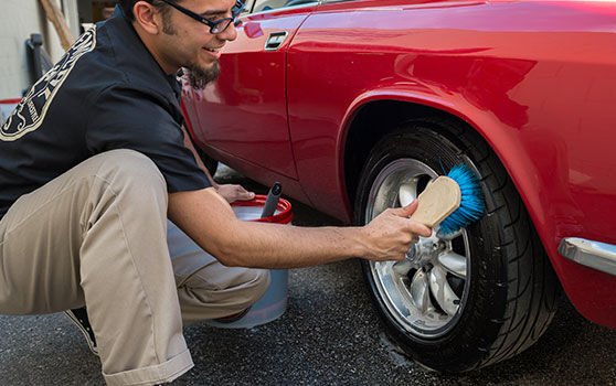 Cleaning Car Tire with a Brush