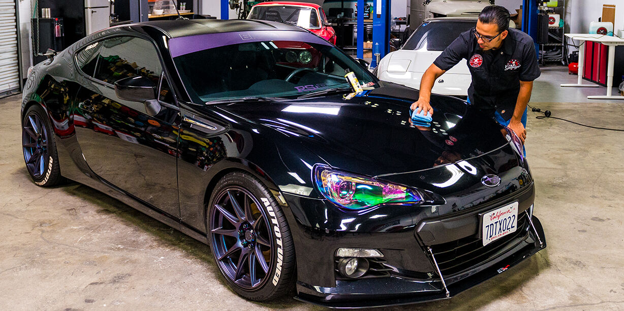 Black Subaru Being Waxed at a Detail Garage