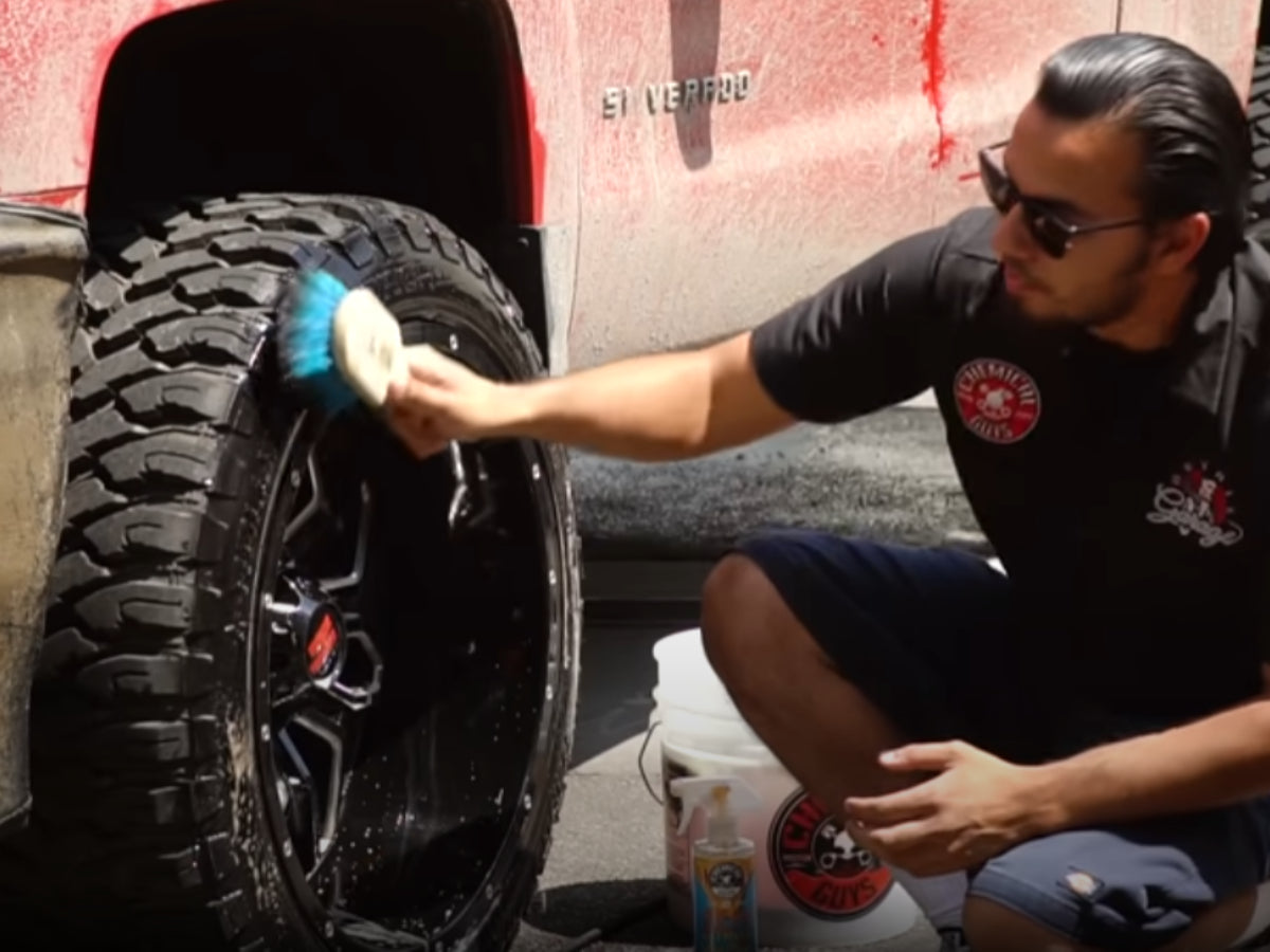 Muddy truck tire being cleaned
