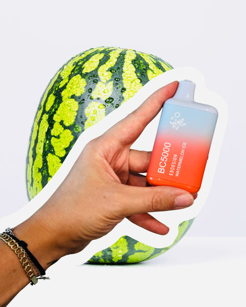 holding watermelon ice disposable device on a watermelon background