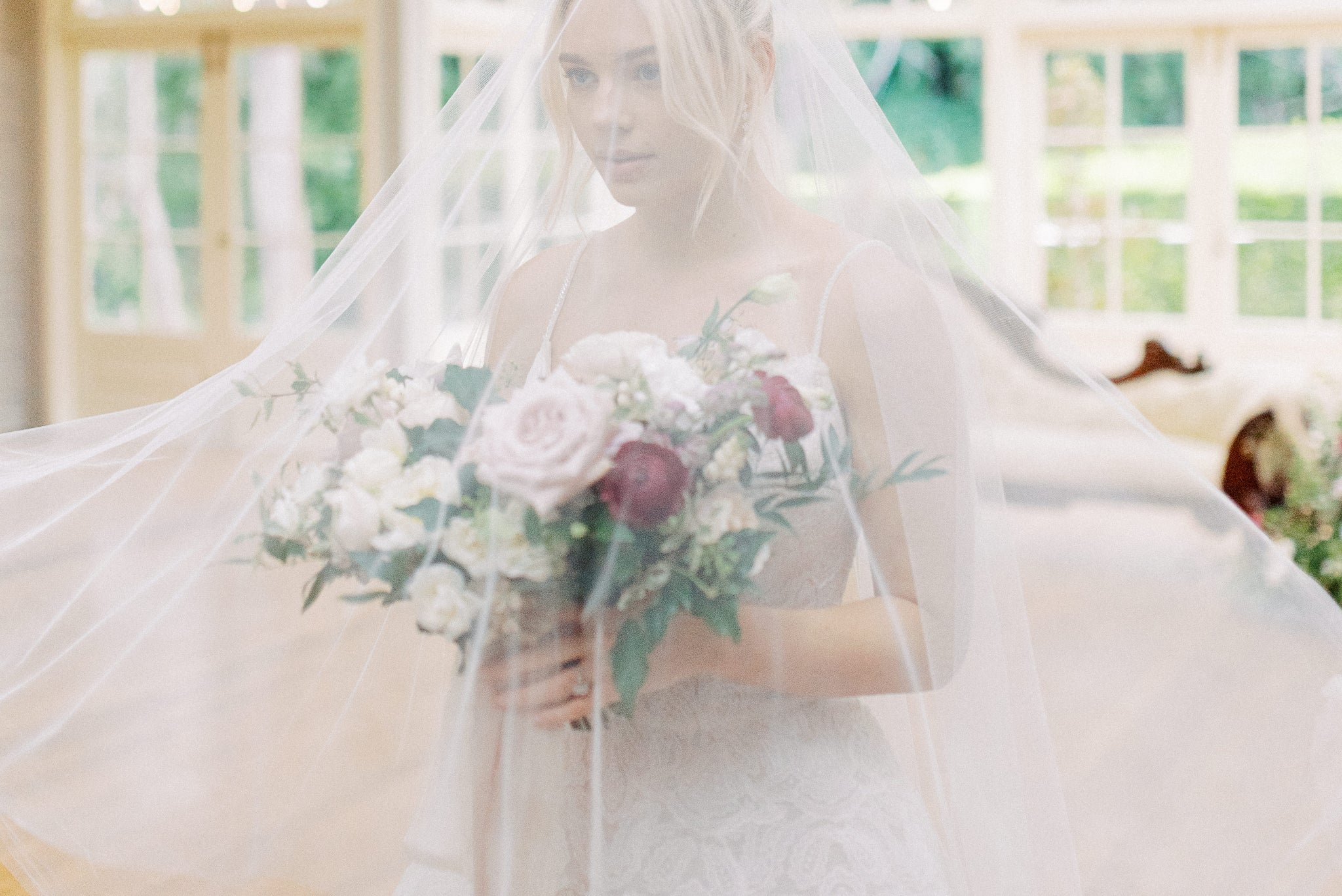 brisbane bride to be wearing bridal veil with bouquet of flowers
