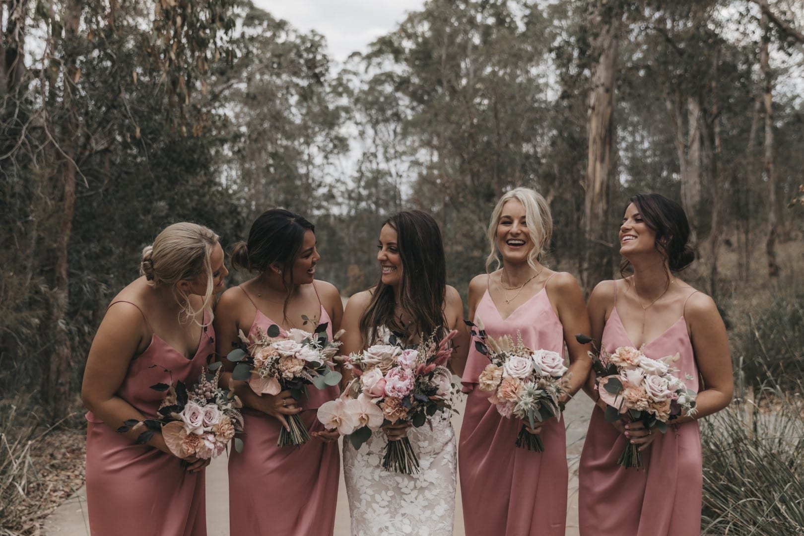 Julia wears the Livie by Enzoani wedding dress with bridesmaids in pink