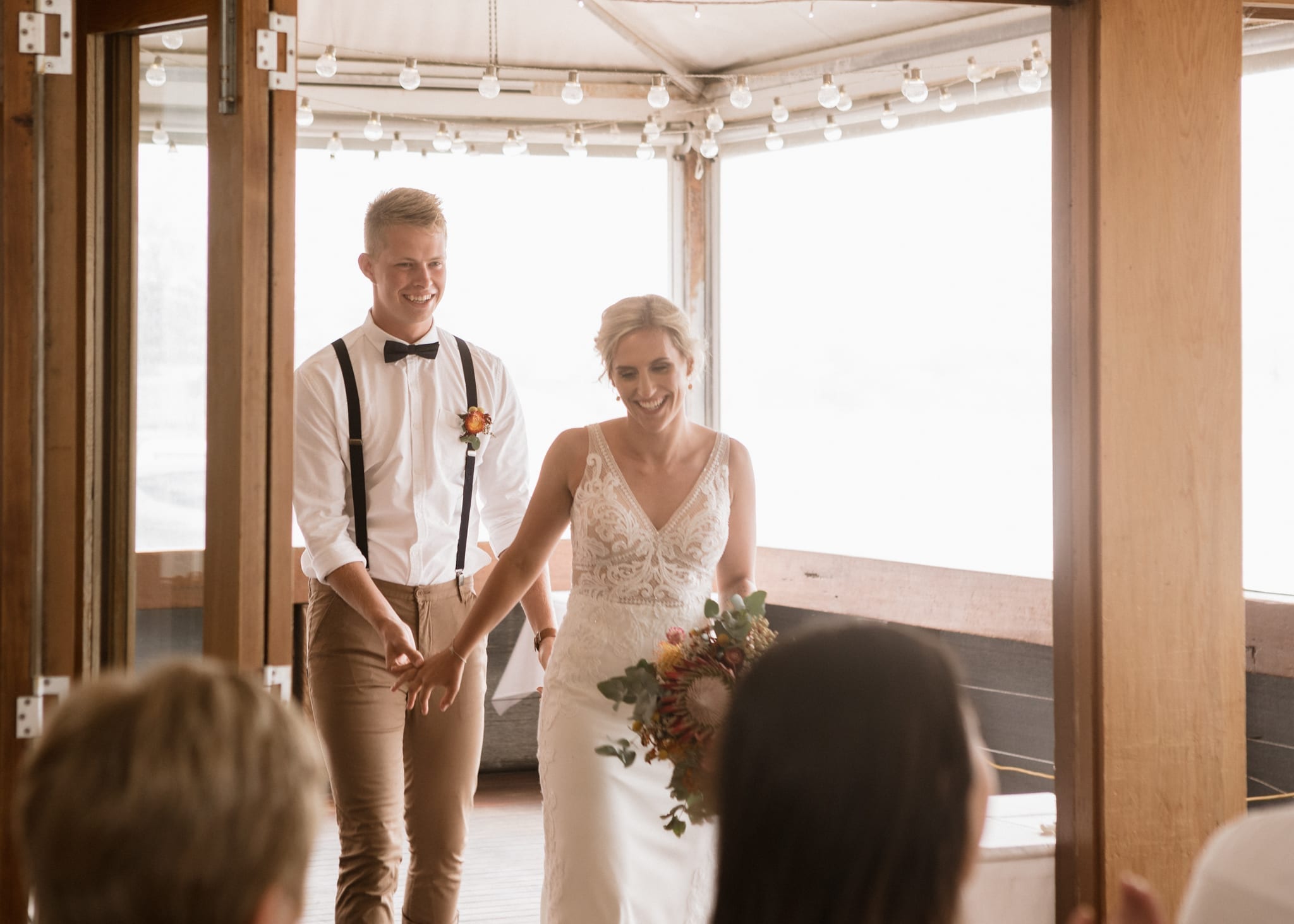 Bride and Groom entering wedding reception at The Flying Fish