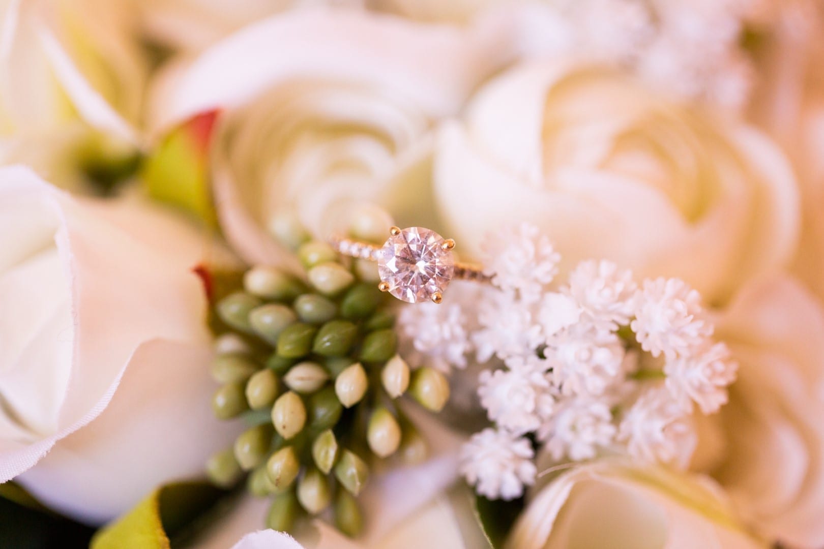 Beautiful engagement ring sat on bouquet. 