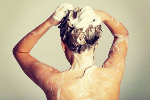 Woman Massaging Scalp and Washing Hair