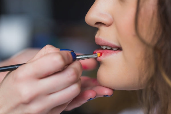 Woman Applying Lipstick | ISA Professional