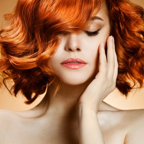 Short Wavy Haired Redhead Woman Touching Her Cheek | ISA Professional