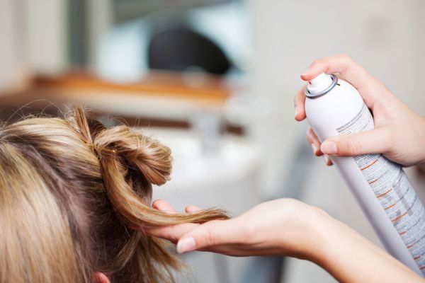 Stylist Applying Hair Spray To Client's Hair ISA Professional