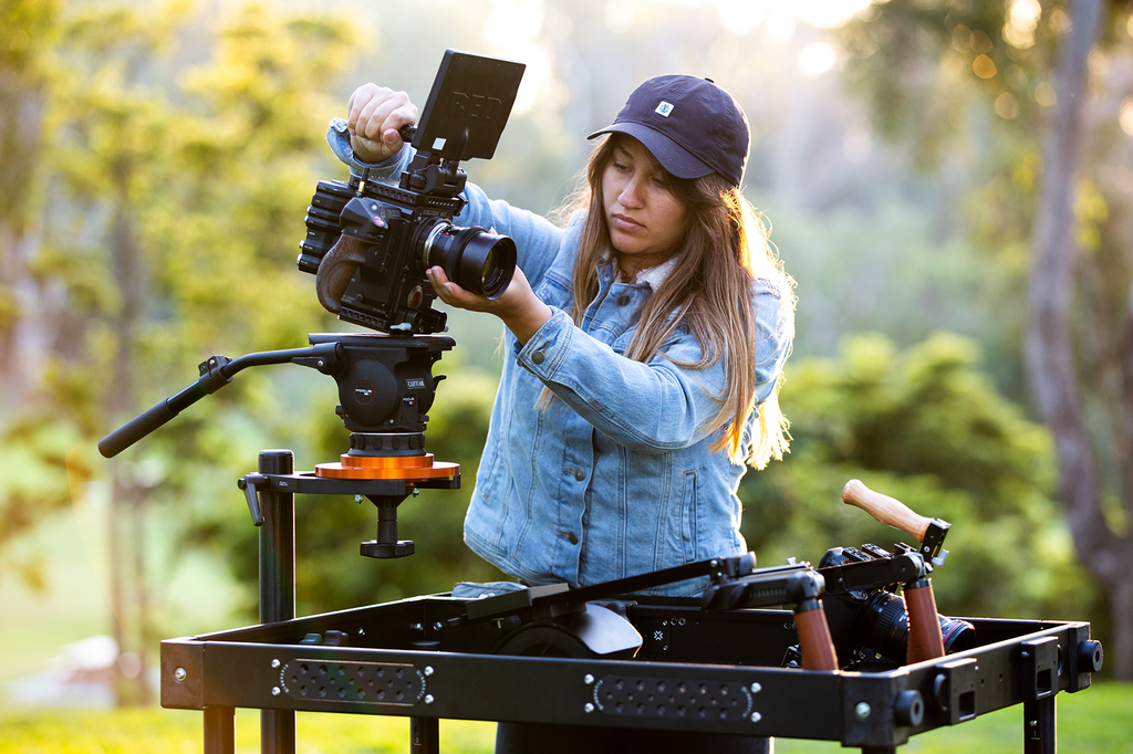 A Woman is mounting a RED DSCM2 onto an INOVATIV Camera Mount System.