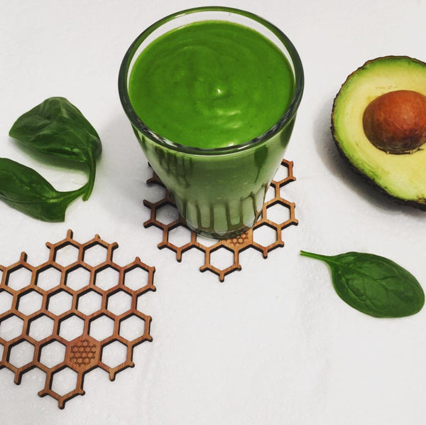 Green smoothie on honeycomb coasters