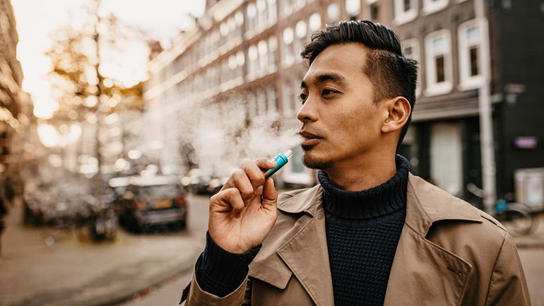 Man in street vaping