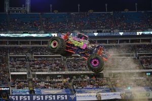 Ramer catching "big air" in her monster truck, Wildflower.