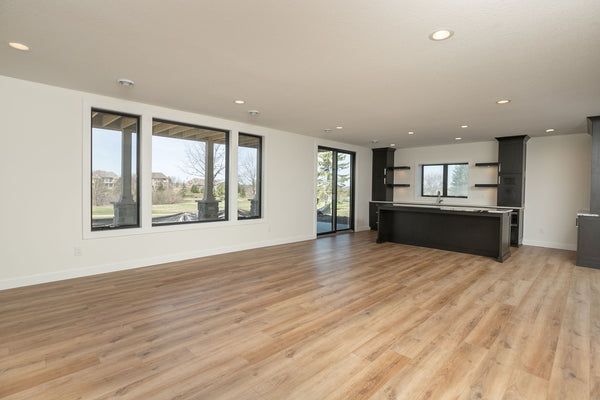 An unstaged family room and bar area in a new construction home