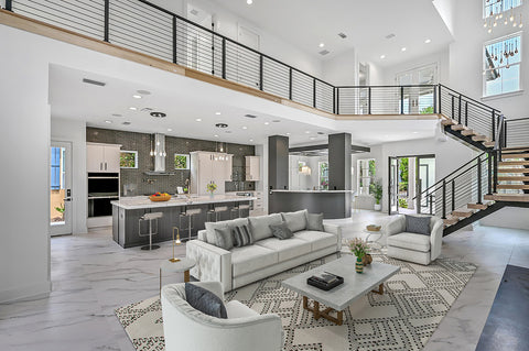 Virtually staged scene within the same home, with white couch, white and gold side tables and coffee table, and white barstools