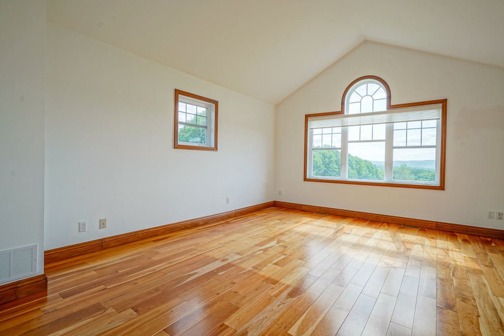 Empty master bedroom in an older home for sale