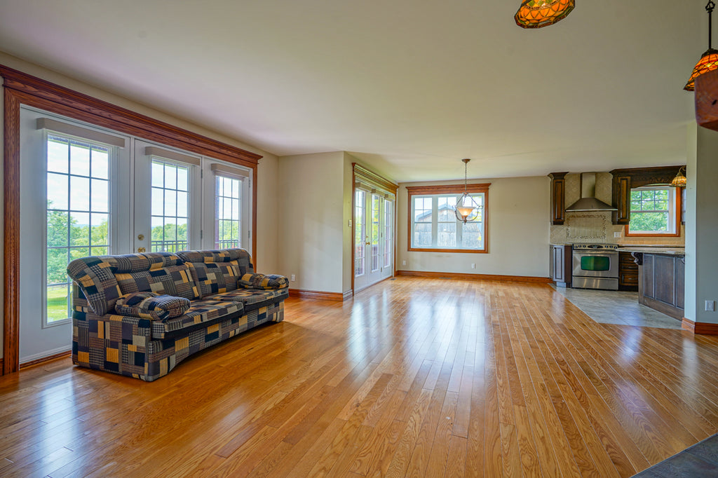 An unstaged, empty living area in a vacant home for sale