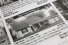 Photo of an old black and white newspaper clipping advertising an open house.