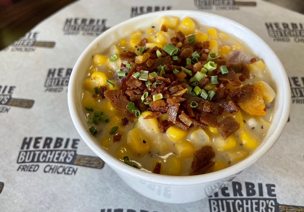 bowl of vegan creamed corn topped with plant based bacon