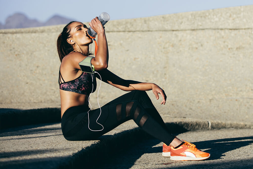 girl hydrating after a workout