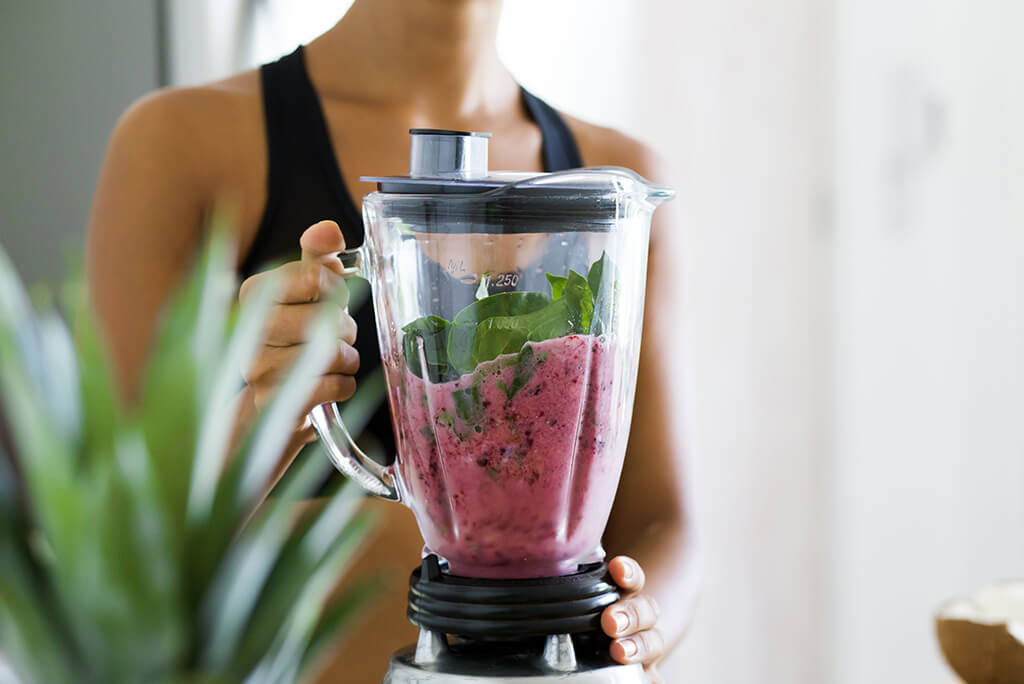 girl preparing smoothies