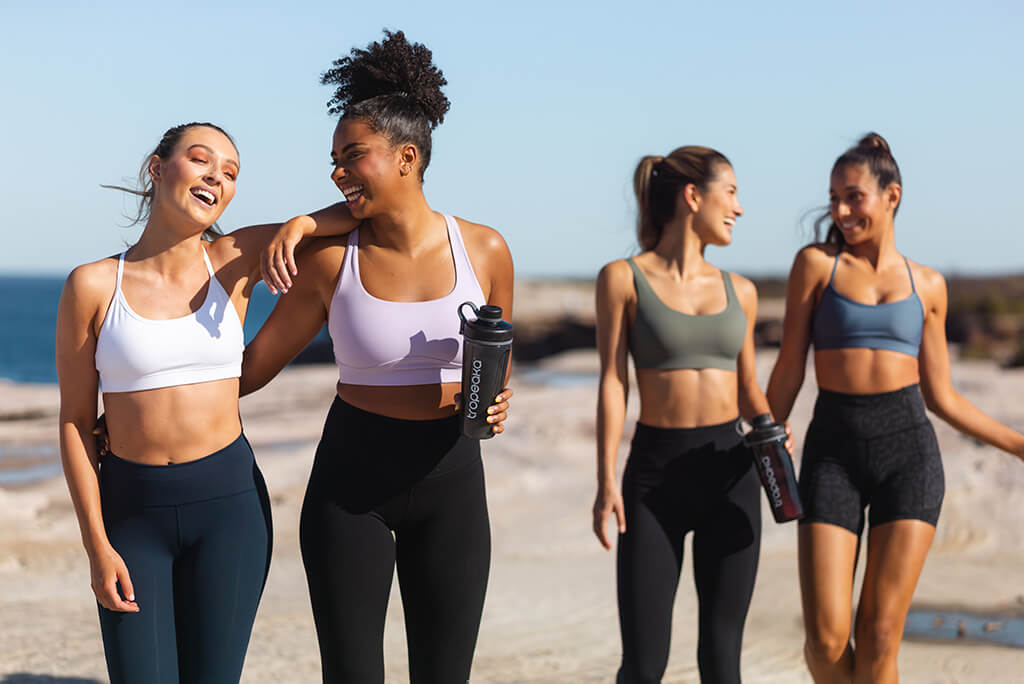 group of girls drinking protein supplement