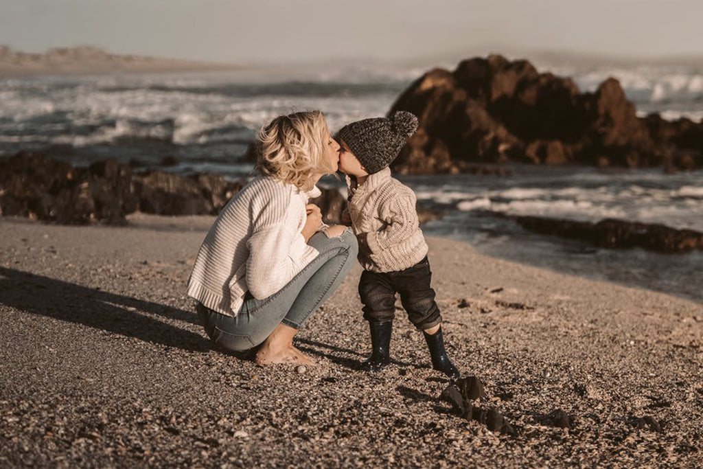 mom and child on a beach