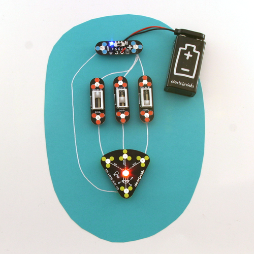 A power module, three switch mosules and a red-green-blue LED module atop a color blender circuit made of conductive silver ink