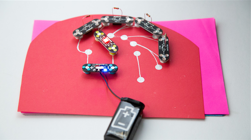 Circuit Scribe conductive silver ink circuit with a power module, red-blue LED module and four DIY connectors making a potentiometer