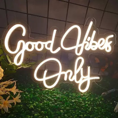 the image is showing a pleasant good vibes only neon sign