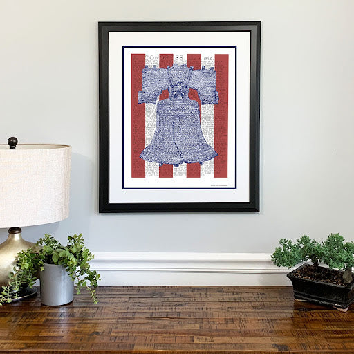 Framed word art print of Liberty Bell, handwritten with Declaration of Independence text, hangs on wall and is a great gift.