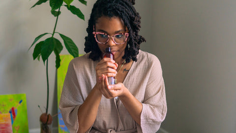 picture of woman smelling some essential oils to regain her sense of smell