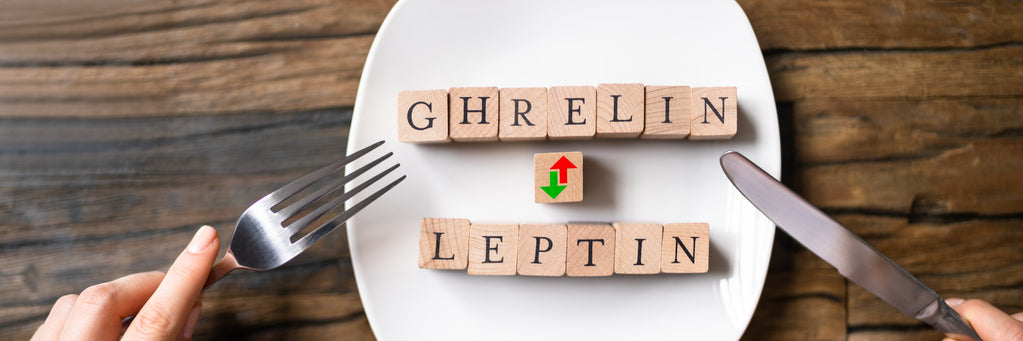 An image of the words ghrelin and leptin spelled out on small wooden tiles on a dinner plate. 