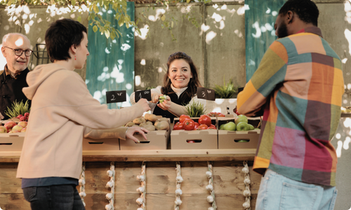 2 people shopping at the farmers market