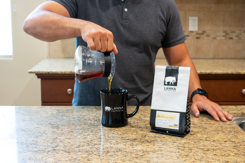 pouring coffee from Hario glass range server into coffee mug