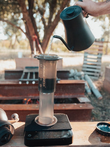 water from electric kettle being poured into AeroPress coffee maker