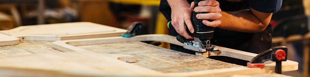 Furniture Worker in factory with drill in hand