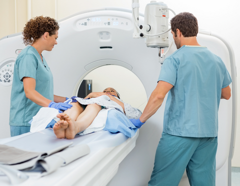 Practitioners and patient during an imaging scan