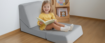 A little girl sitting on a Plush Kids Floor Lounger reading nook reading a book