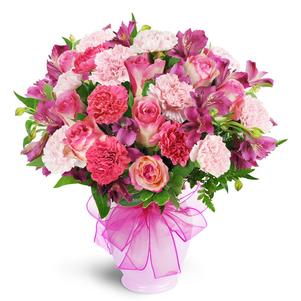 Berry Perfection premium flower arrangement. A dazzling array of pink roses, pale pink and fuchsia carnations, and deep mauve alstroemeria.