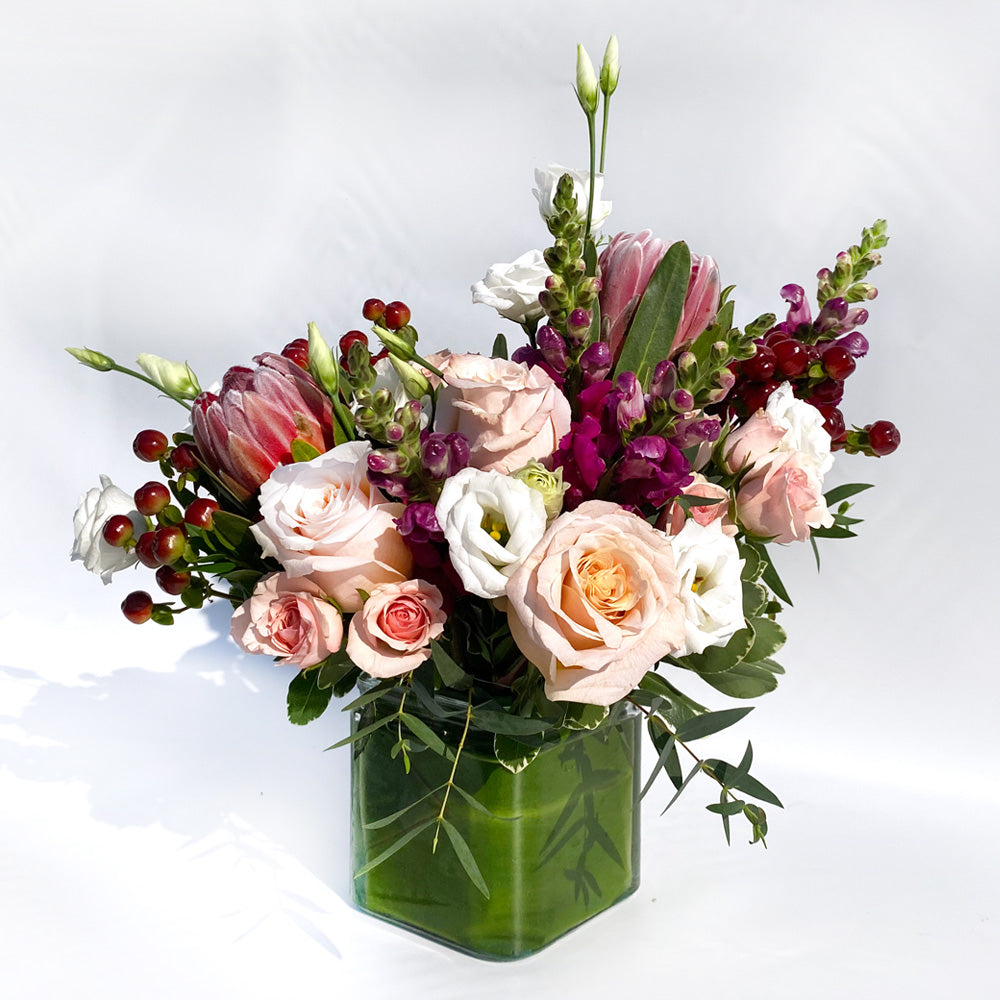 You Make Me Blush with protea, lisianthus, snapdragon. Features blush, red and white 
