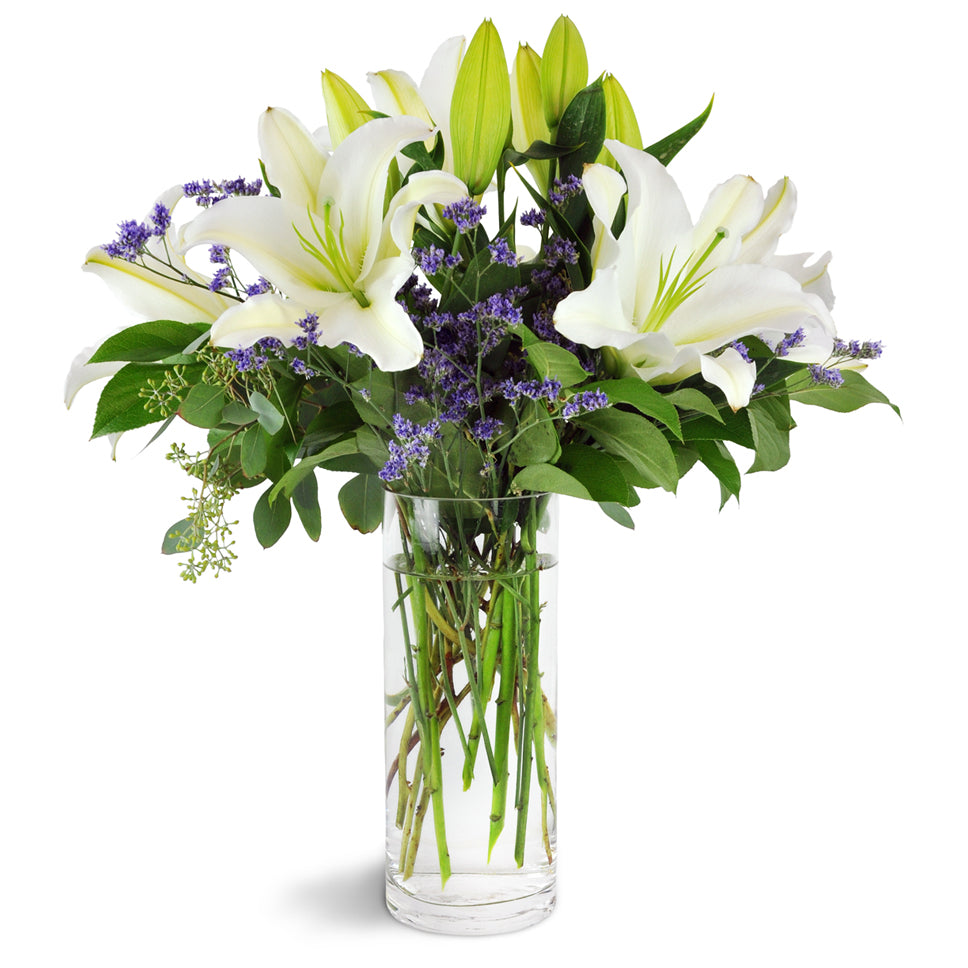 Height of Elegance. This lavish display of tall white lilies, purple caspia, and seeded eucalyptus will exceed all expectations.